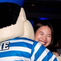 Grad smiles hugging Louie